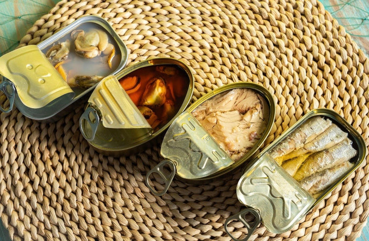 Multiple cans of seafoods pilled in a random way